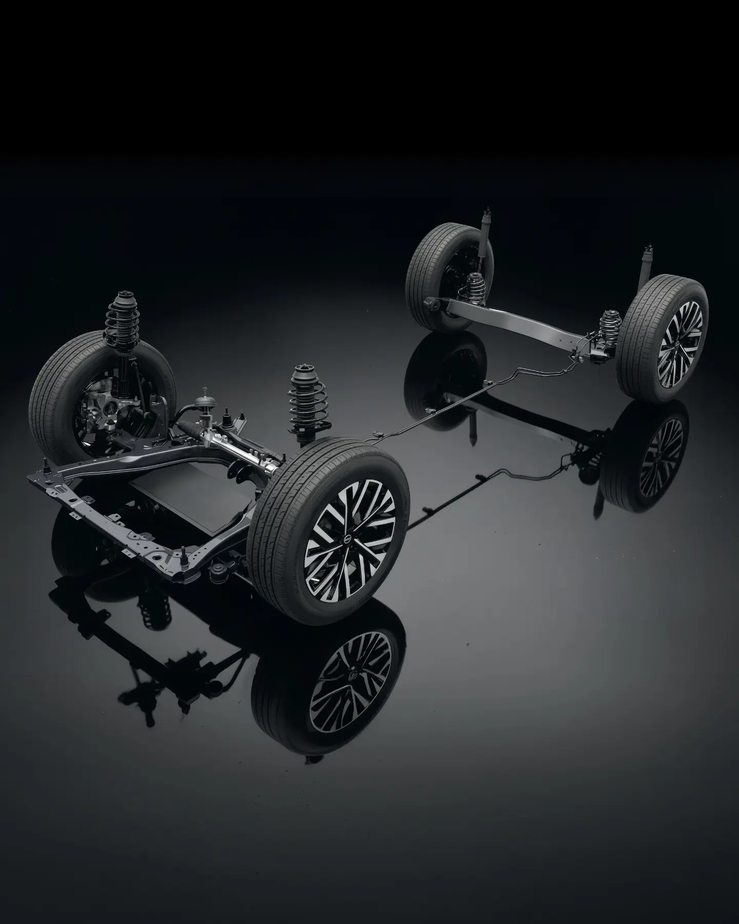 Underside of a car showing four wheels with coil spring suspension on a glossy black surface.