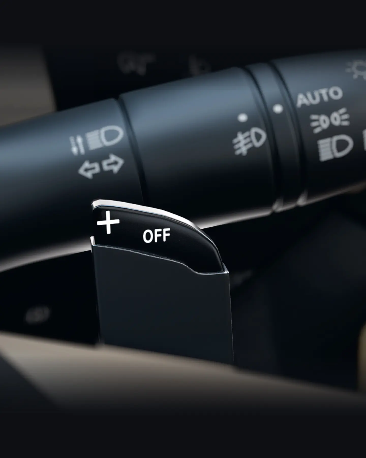 Close-up of a car stalk showing headlight, turn signal, and auto/off controls for exterior lights and indicators